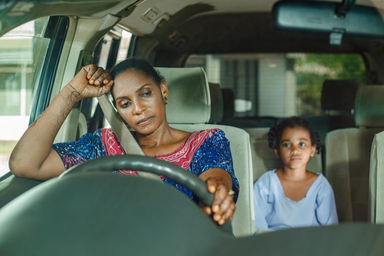 a woman and a child sitting in a car