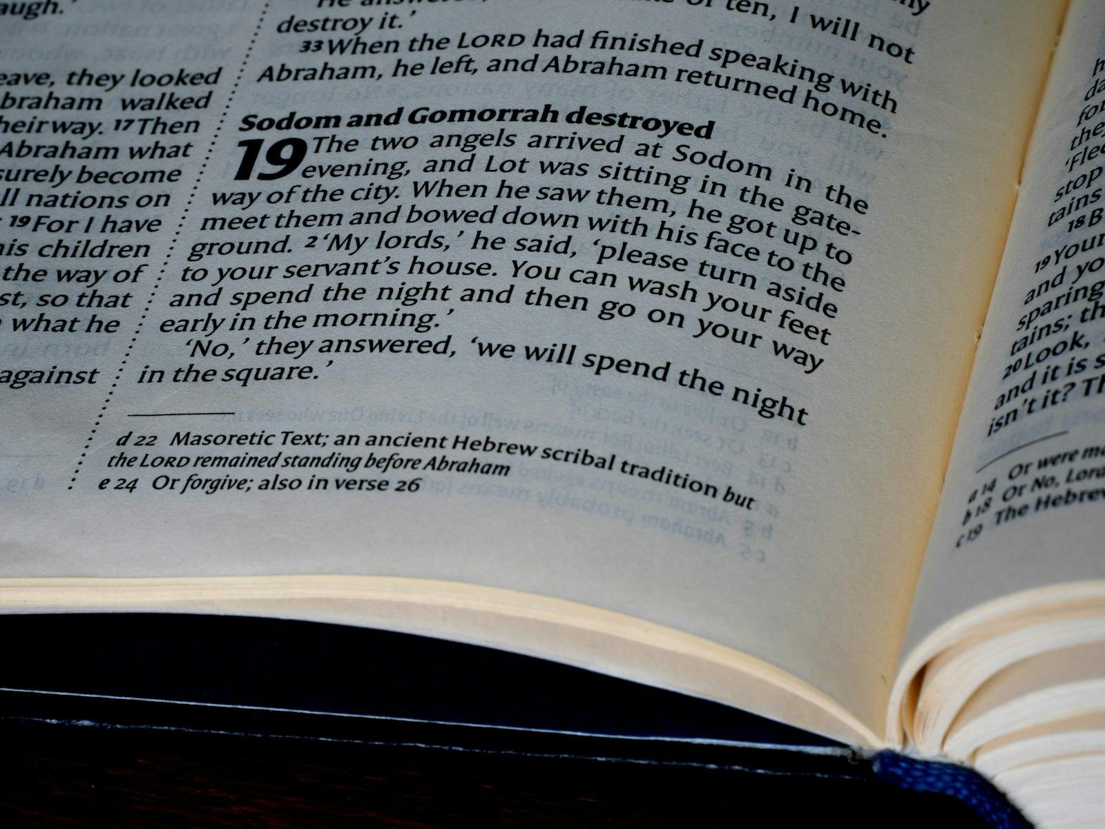 Detailed close-up of a page from the Bible's Book of Genesis, highlighting scripture text.