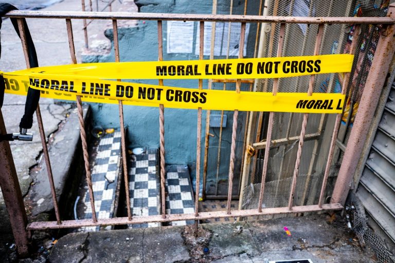 Yellow caution tape reads "moral line do not cross"
